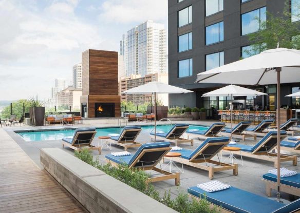 rooftop pool with cushioned loungers