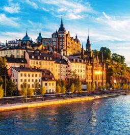 river next to European city skyline with historic buildings