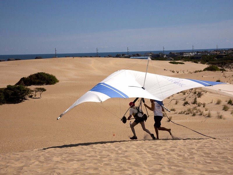 Students learning to fly at the largest Hang Gliding School in the country located in the sand dunes of Jockey's Ridge State Park