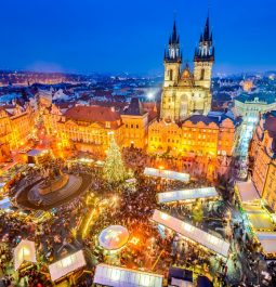 Old historic square in European city with Christmas market stalls and lights