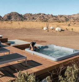 jacuzzi built into wooden deck in middle of desert landscape