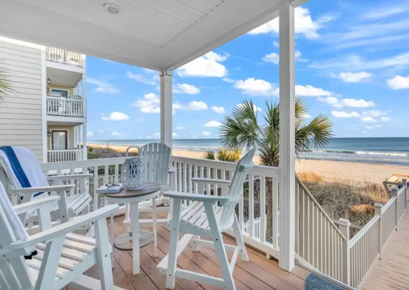 porch with chairs that looks out on the beach and ocean