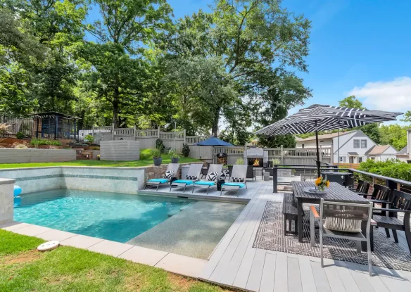 In-ground pool with patio furniture